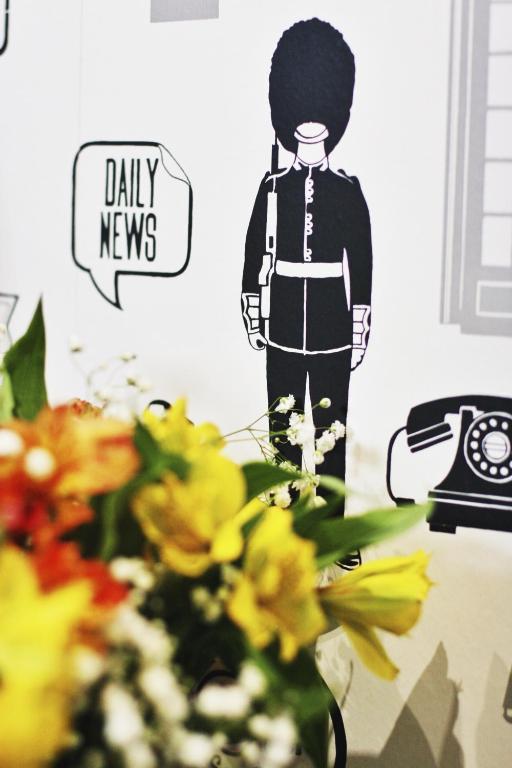 a wall with a picture of a man on a telephone at Beaconsfield Hotel in London