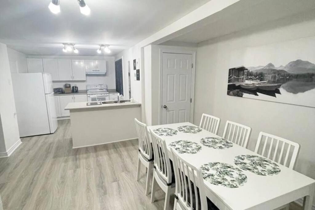 a kitchen and dining room with a table and chairs at Central, convenient and comfortable 3 Bedrooms house near downtown Gatineau/Ottawa with free parking in Gatineau