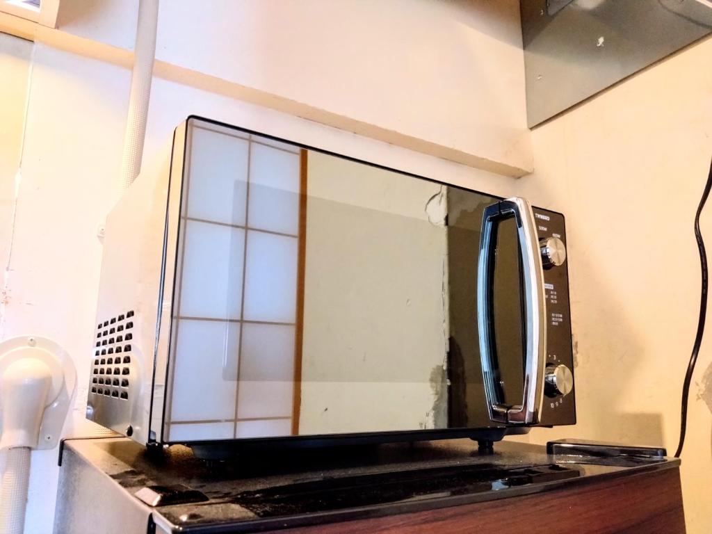 TV a/nebo společenská místnost v ubytování 酒と宿と不動産-yado-