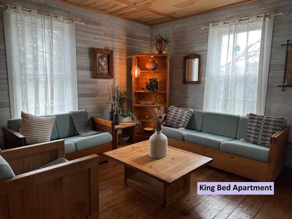 a living room with blue couches and a table at Retreat near Beaches in Gloucester