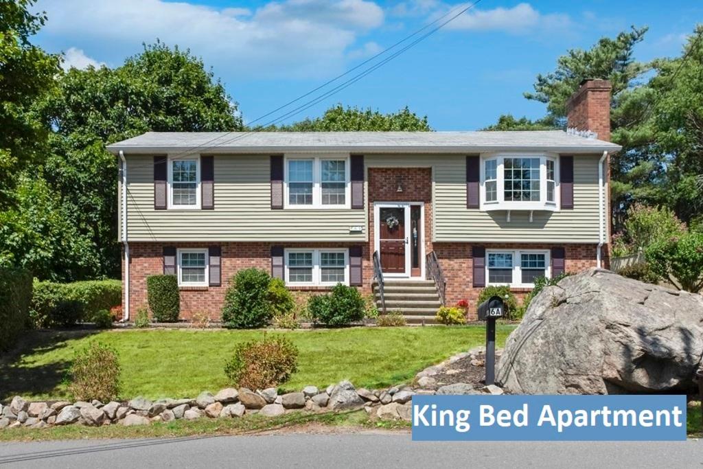 a house with a big rock in front of it at Ocean Breeze-8min Walk to Beach in Gloucester