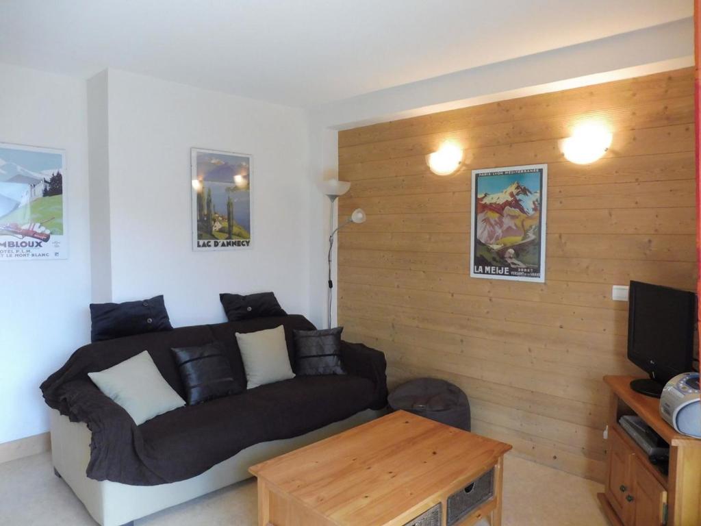 a living room with a couch and a table at Appartement Crest-Voland, 3 pièces, 4 personnes - FR-1-595-76 in Crest-Voland