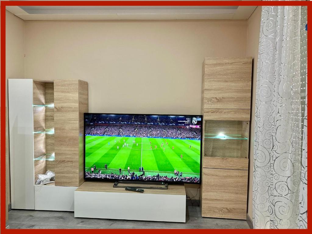 a television in a living room with a soccer game at Duplex en centro de calella in Calella