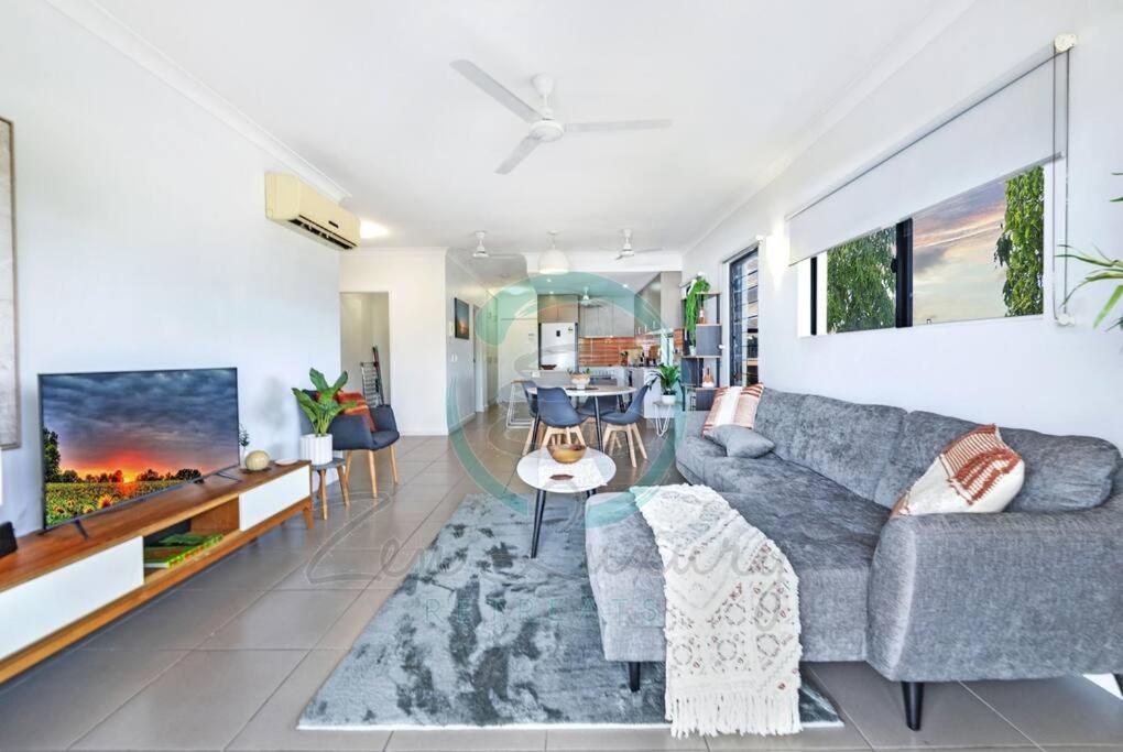 a living room with a couch and a table at ZEN NOMAD 2-BR Nightcliff Apt Near Markets & Shops in Nightcliff