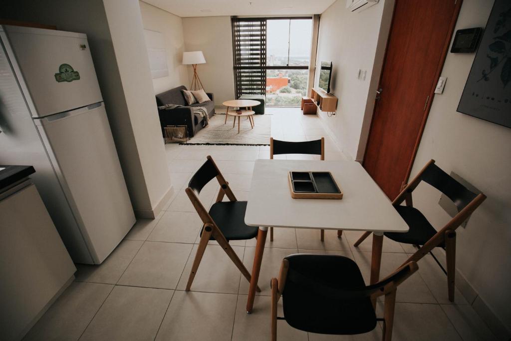 a kitchen and dining room with a table and chairs at Miradores del Chaco in Asuncion