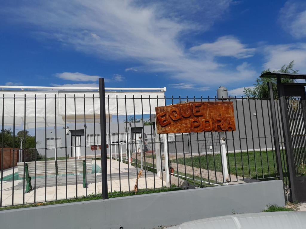 a fence with a sign that says on it at Complejo EQUE PORA in Federación