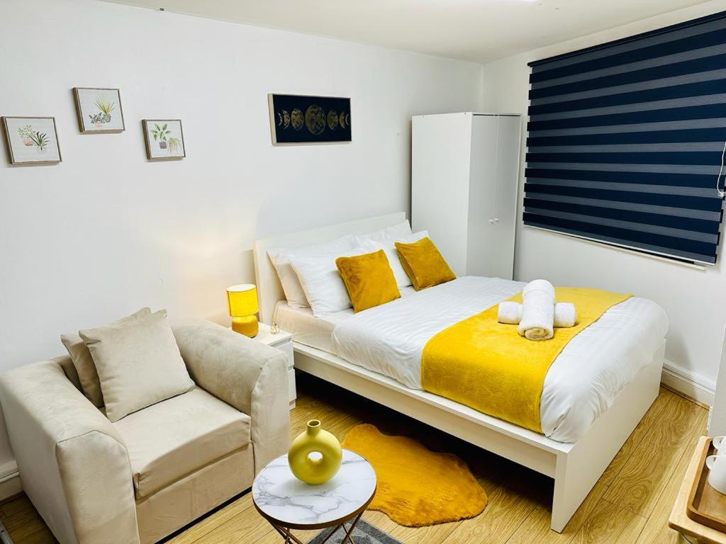 a small bedroom with a bed and a couch at Premium Studio Flat 04 in Central London in London