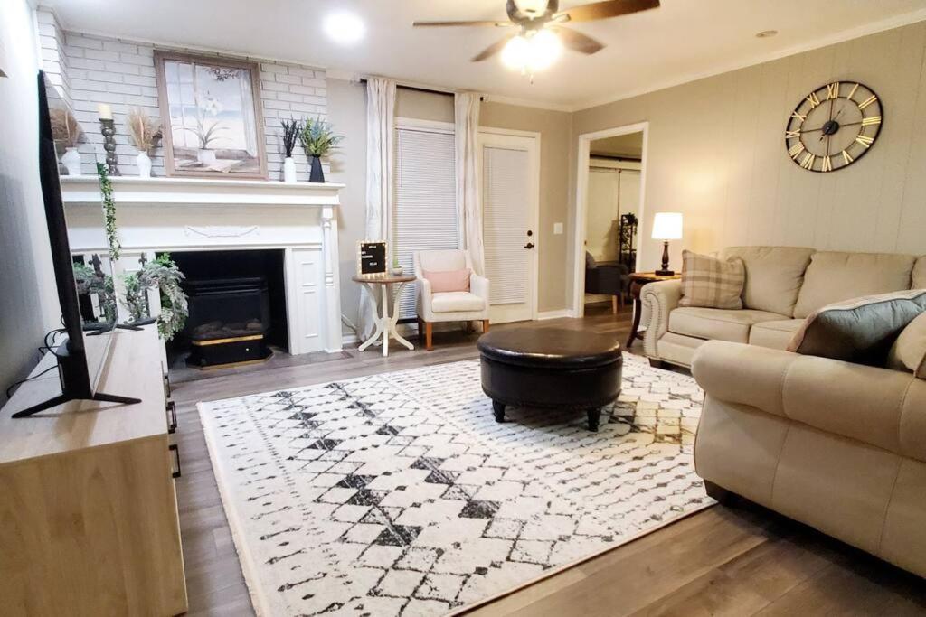 a living room with a couch and a fireplace at Charming Mid-Century Home in Central Location in Springfield