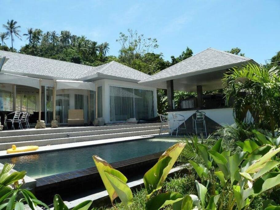 a house with a swimming pool in front of it at La maison du bonheur à samui in Koh Samui