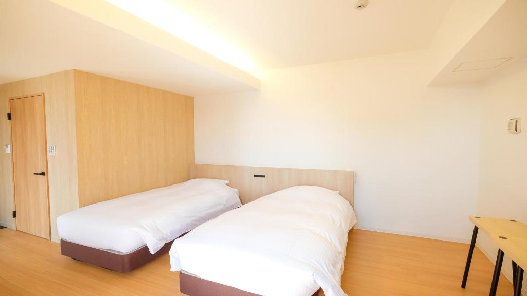Postel nebo postele na pokoji v ubytování ELE Hotel Kuzuha