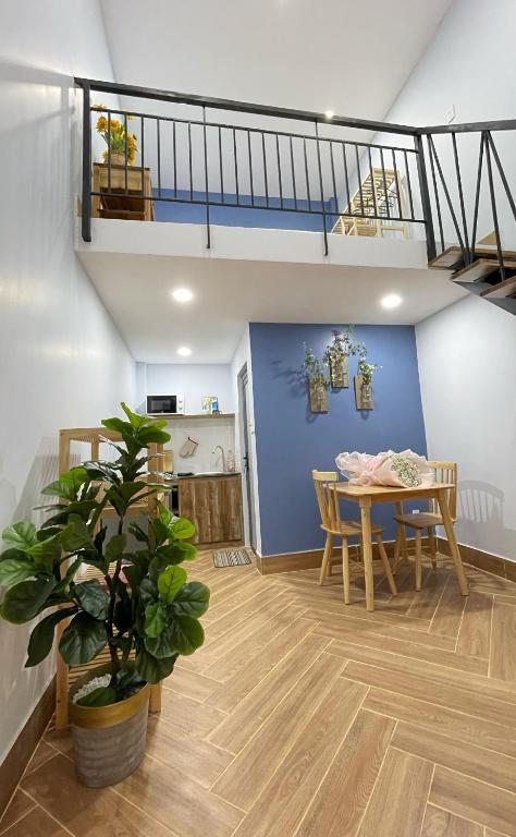 a dining room with a table and a blue wall at Vania House in Ho Chi Minh City