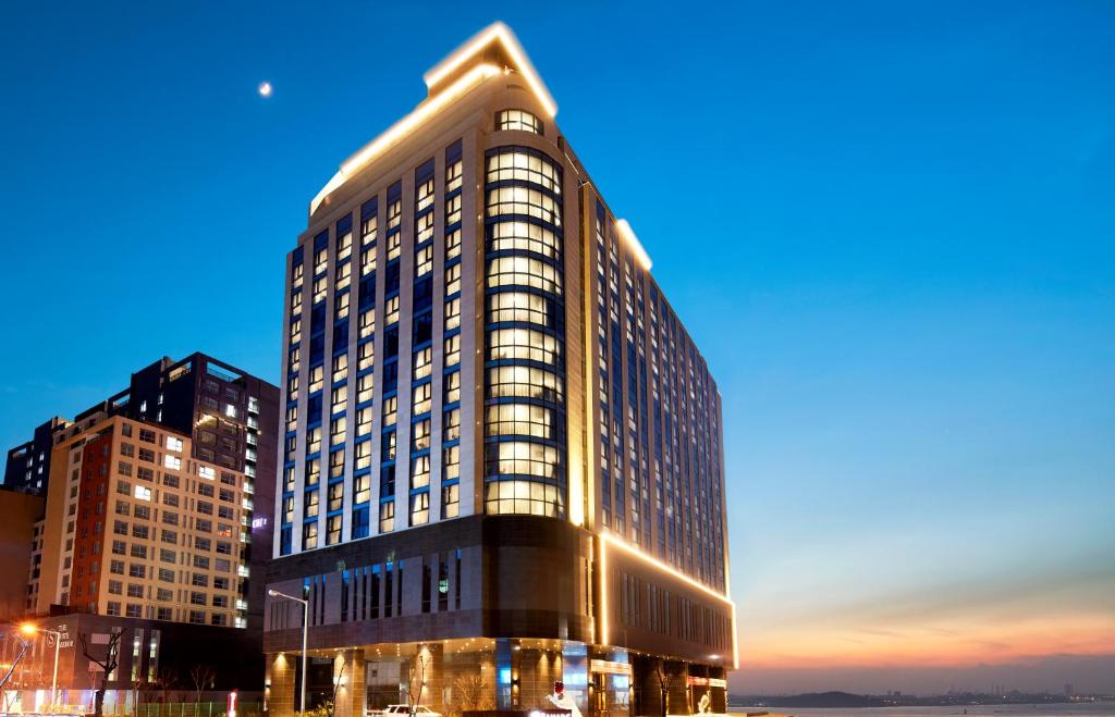 un edificio alto al anochecer en Pyeongtaek K-tree Hotel, en Pyeongtaek