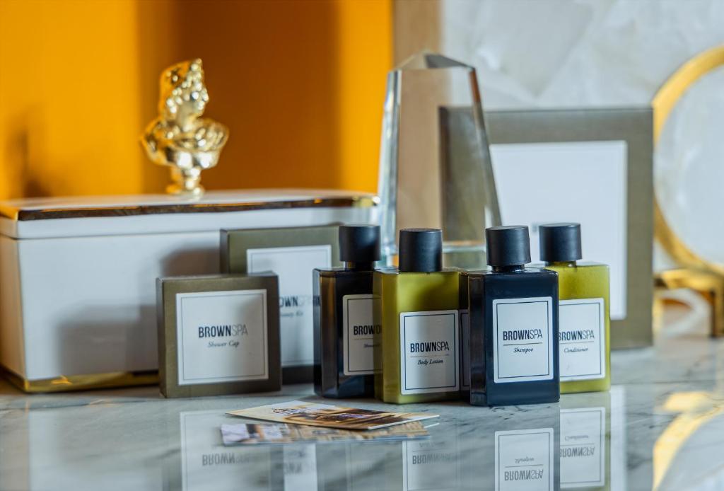 a group of five bottles of perfume on a table at Villa Brown Moshava - a member of Brown Hotels in Jerusalem