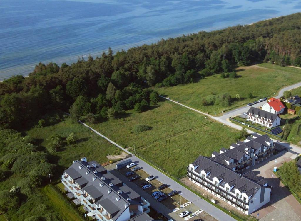 an aerial view of a house and the water at Apartamenty Lambert Grzybowo in Grzybowo