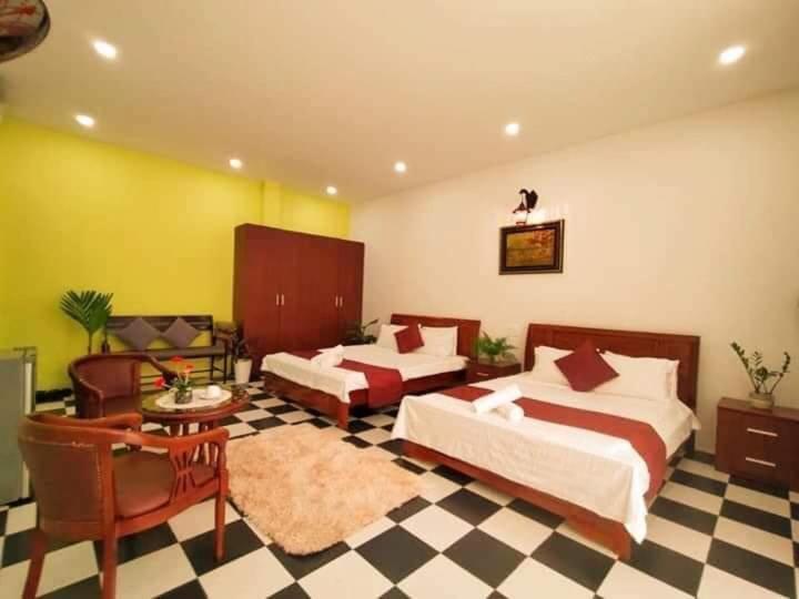 a large bedroom with two beds and a rug at Cheriladyhomestayhue in Hue