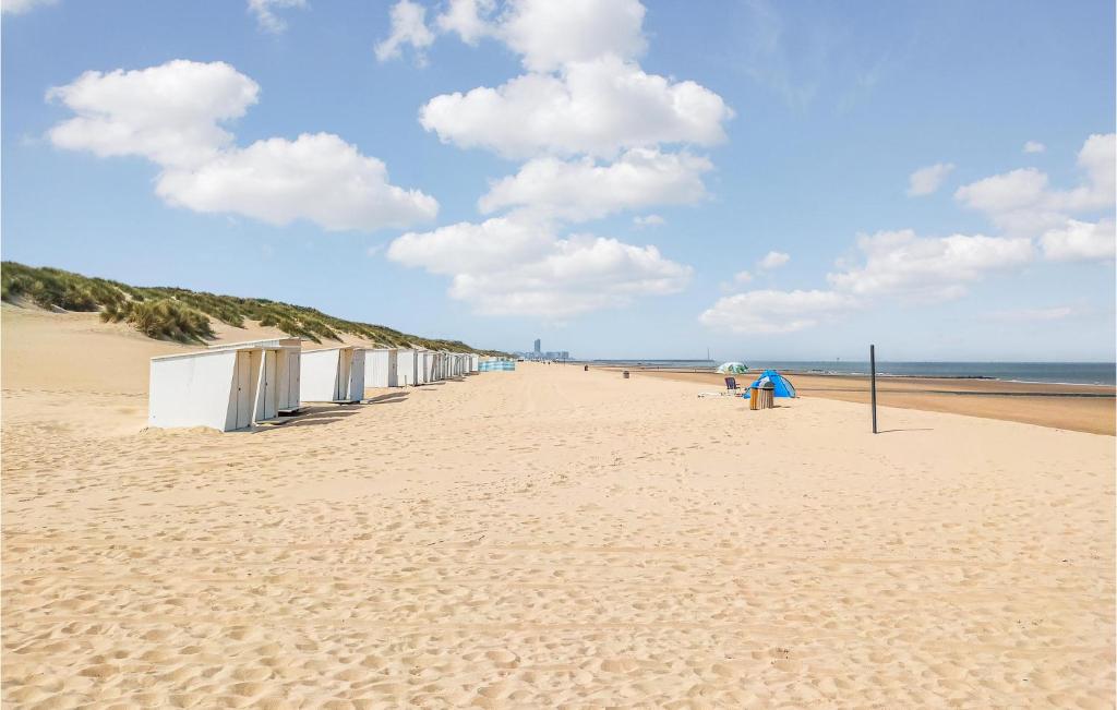 a beach with a row of beach huts on it at Nice Apartment In Bredene With Kitchen in Bredene