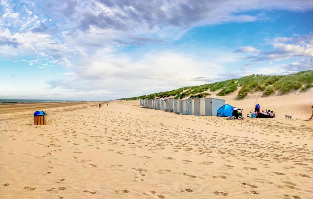 a sandy beach with a row of tents on it at Nice Apartment In Bredene With Kitchen in Bredene