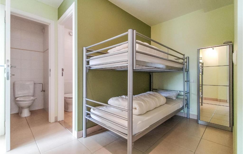 a bunk bed room with a toilet and a bathroom at Nice Apartment In Bredene With Kitchen in Bredene