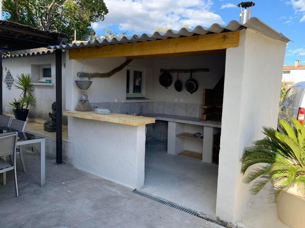 an outdoor kitchen with a counter with pots and pans at Etape du soleil in Lunel