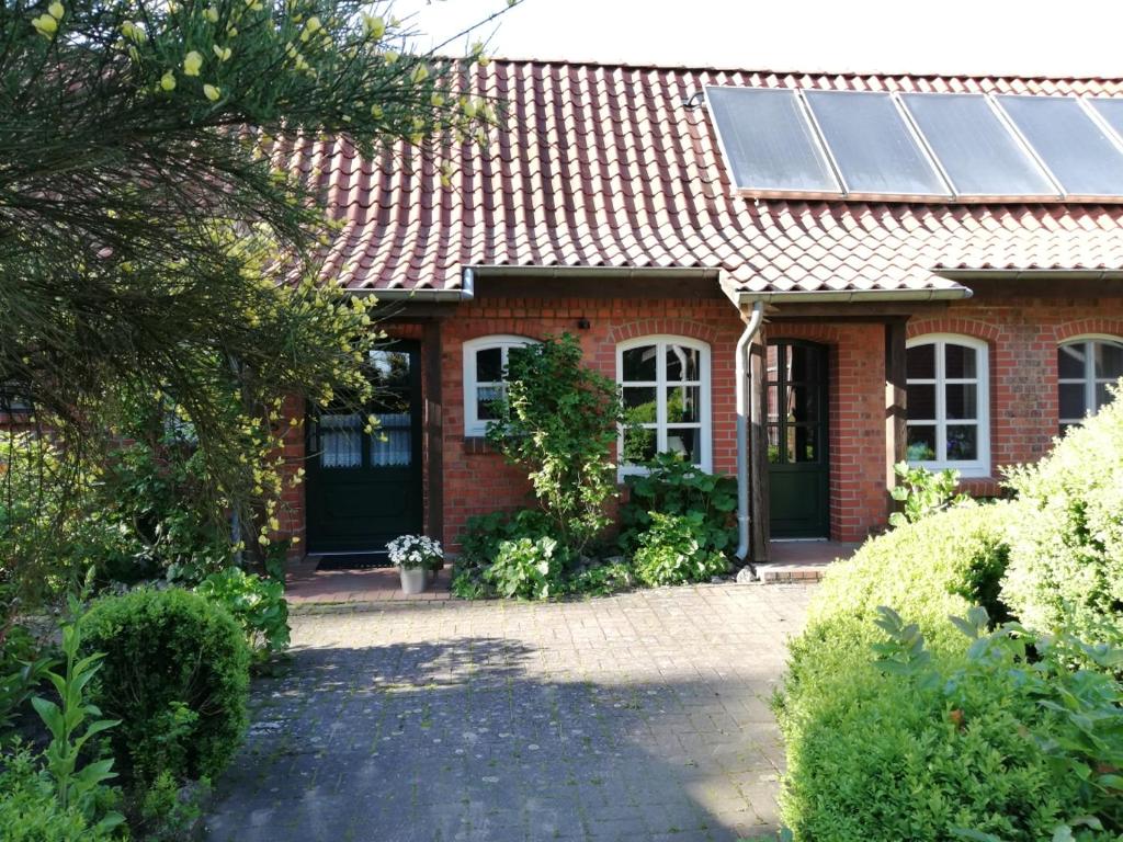 a red brick house with a solar roof at Hof Koopmann in Dahlem