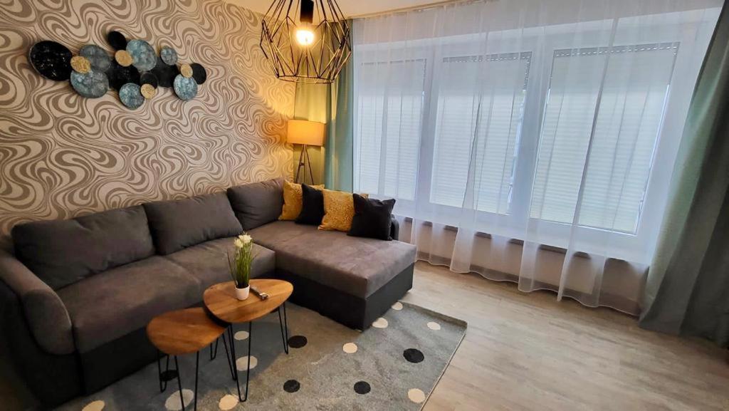 a living room with a couch and a table at 4Rooms Central-Modern near MTU with Balcony, The Beach by Lakescape FeWos in Friedrichshafen