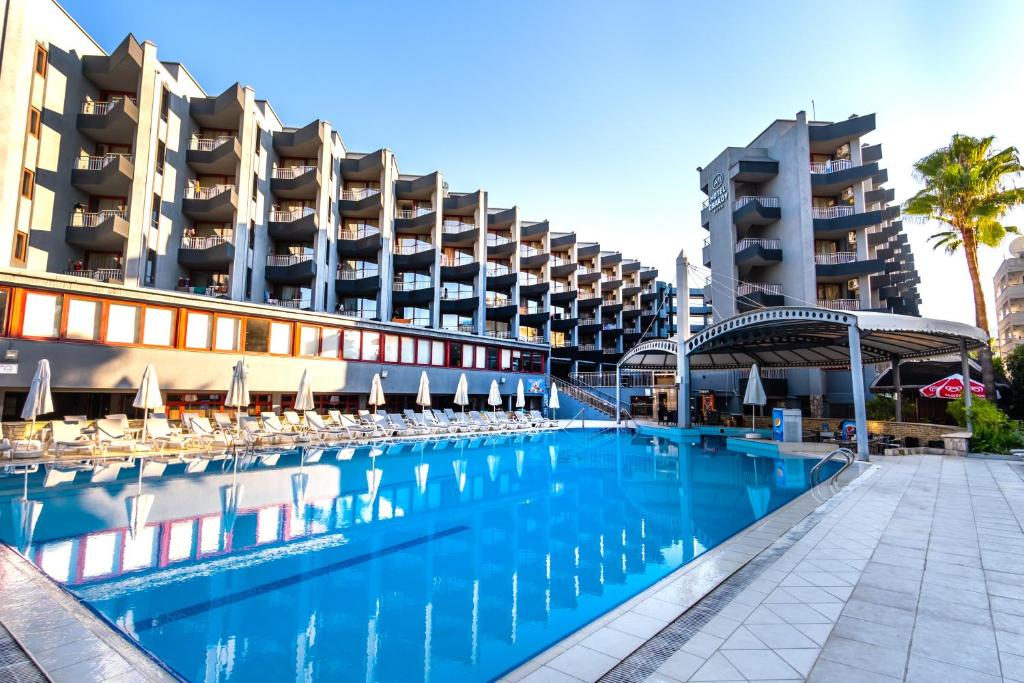 a large swimming pool in front of a building at A11 Hotel Obaköy in Alanya