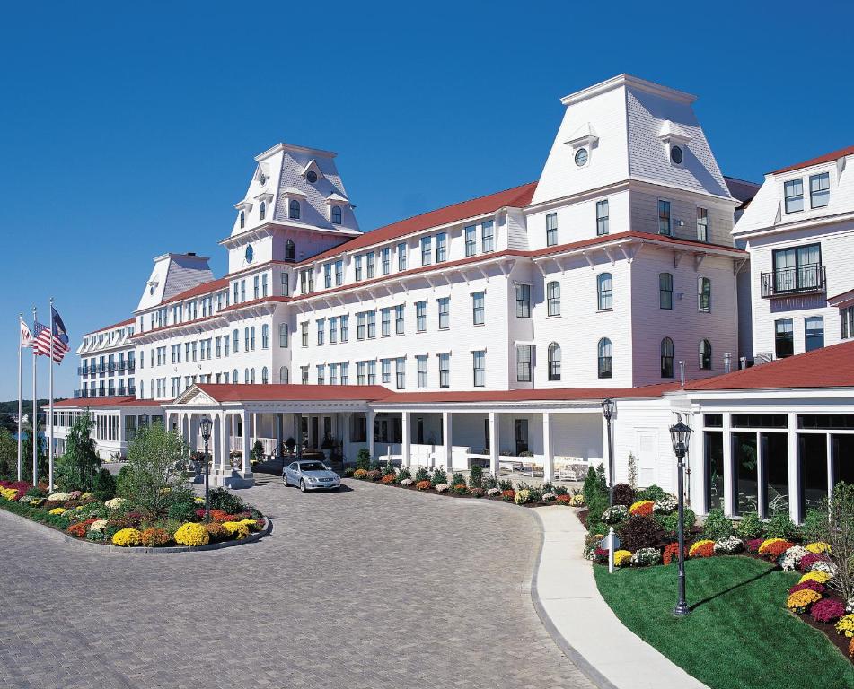 
a large building with a large clock on the front of it at Wentworth by the Sea, A Marriott Hotel & Spa in New Castle
