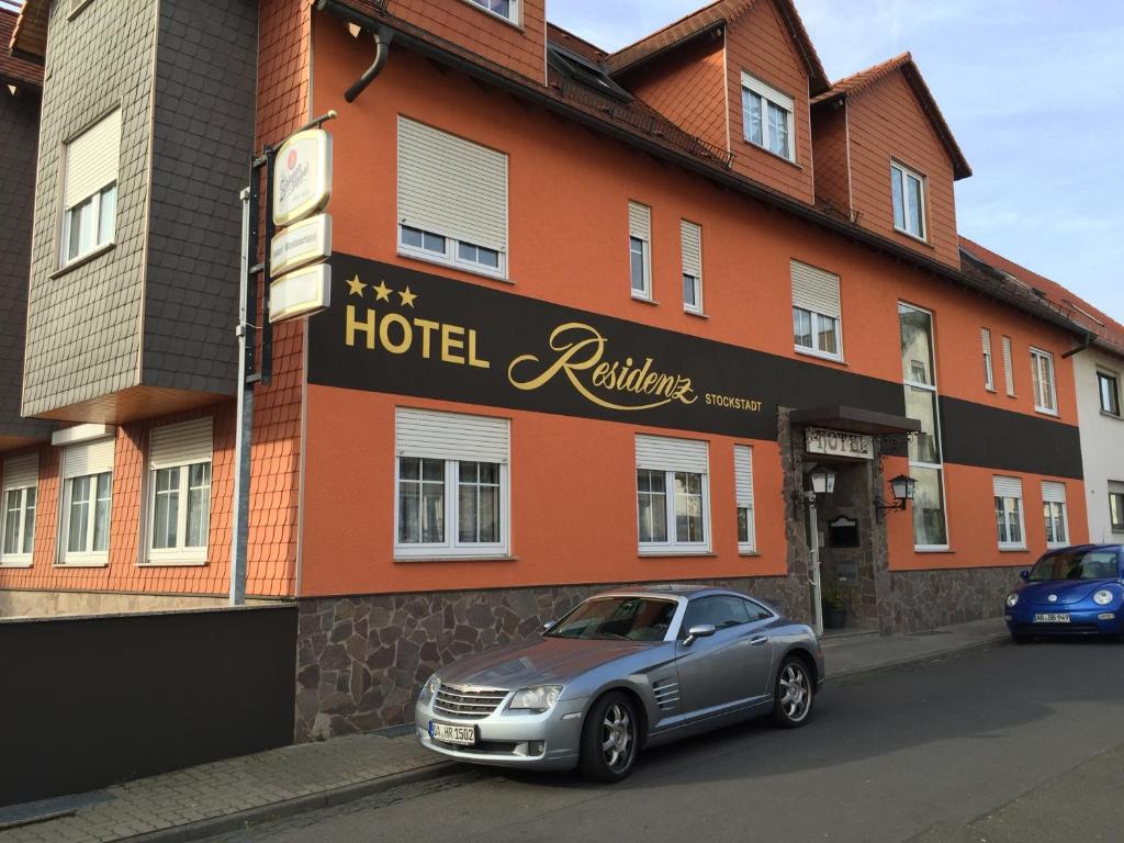 a car parked in front of a hotel building at Hotel Residenz Stockstadt in Stockstadt am Main
