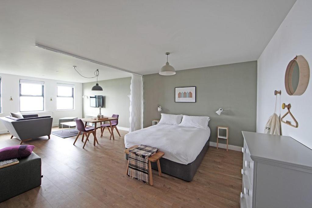 a bedroom with a bed and a living room at Portgordon - 1 Bed Luxury Studio Apartment in Wick
