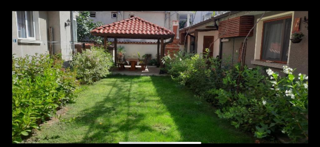 a yard with a gazebo in a house at Guest House Ofilovi in Nesebar