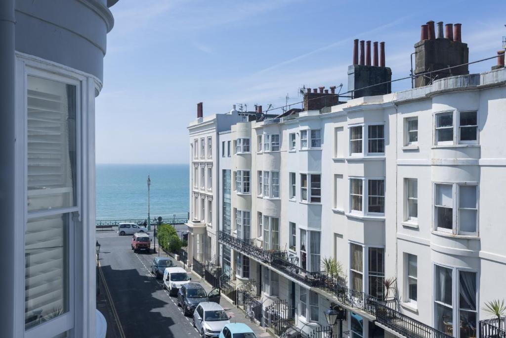 a view of a street with white buildings and the ocean at Brighton Marina House in Brighton & Hove