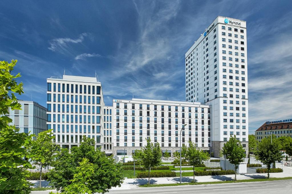 a group of tall white buildings in a city at H2 Hotel München Olympiapark in Munich