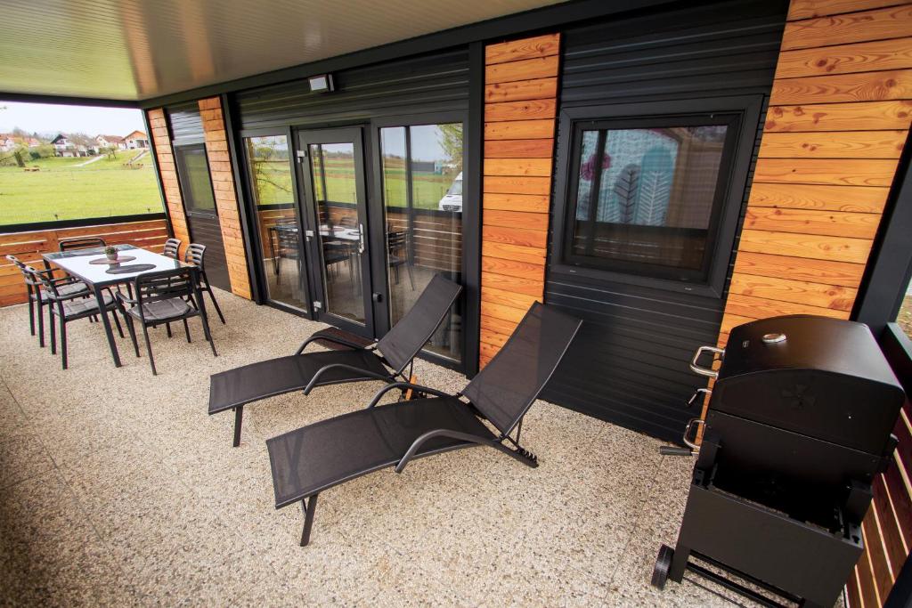 a screened in porch of a house with a table and chairs at Mobile house Tina 31 in Metlika