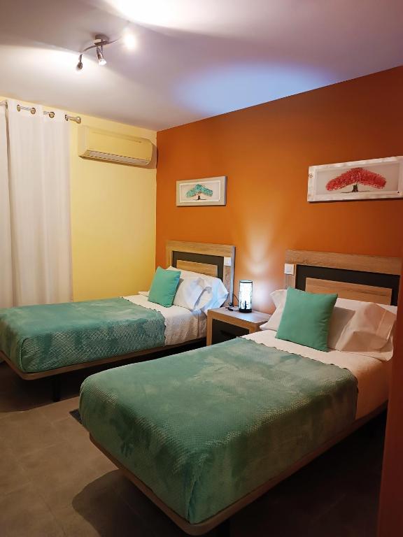 Postel nebo postele na pokoji v ubytování Hotel Alma Rosa