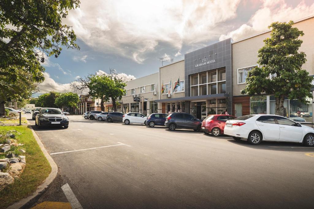 a row of cars parked in front of a building at The Graham Hotel in Grahamstown