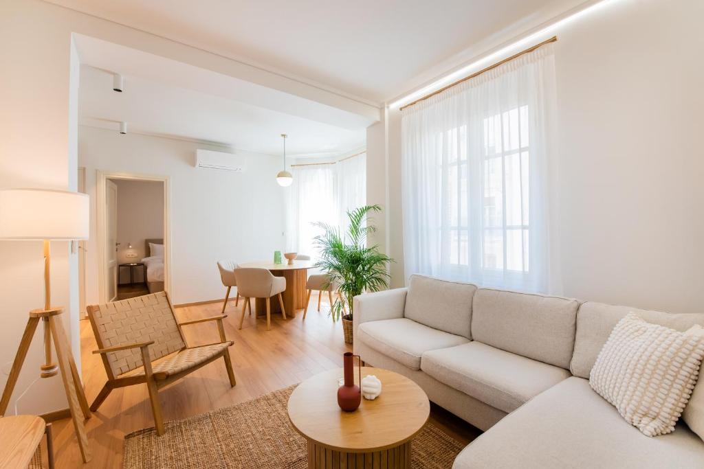 a living room with a couch and a table at #White Lotus by halu! Apartments in Thessaloniki