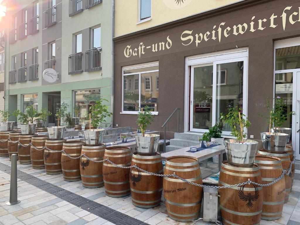 a row of wine barrels in front of a store at Hotel Schwarzer Adler in Heilbad Heiligenstadt