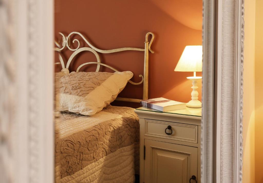 a bedroom with a bed and a lamp on a night stand at Condo in Aegina in Aegina Town