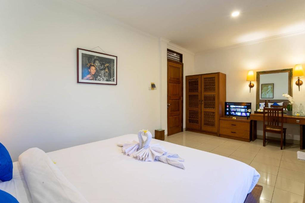 Postel nebo postele na pokoji v ubytování Starloka Saba Bali Hotel