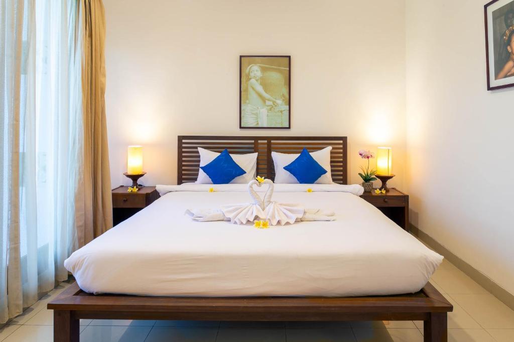 Postel nebo postele na pokoji v ubytování Starloka Saba Bali Hotel