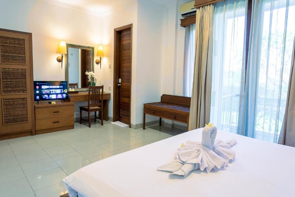 Postel nebo postele na pokoji v ubytování Starloka Saba Bali Hotel
