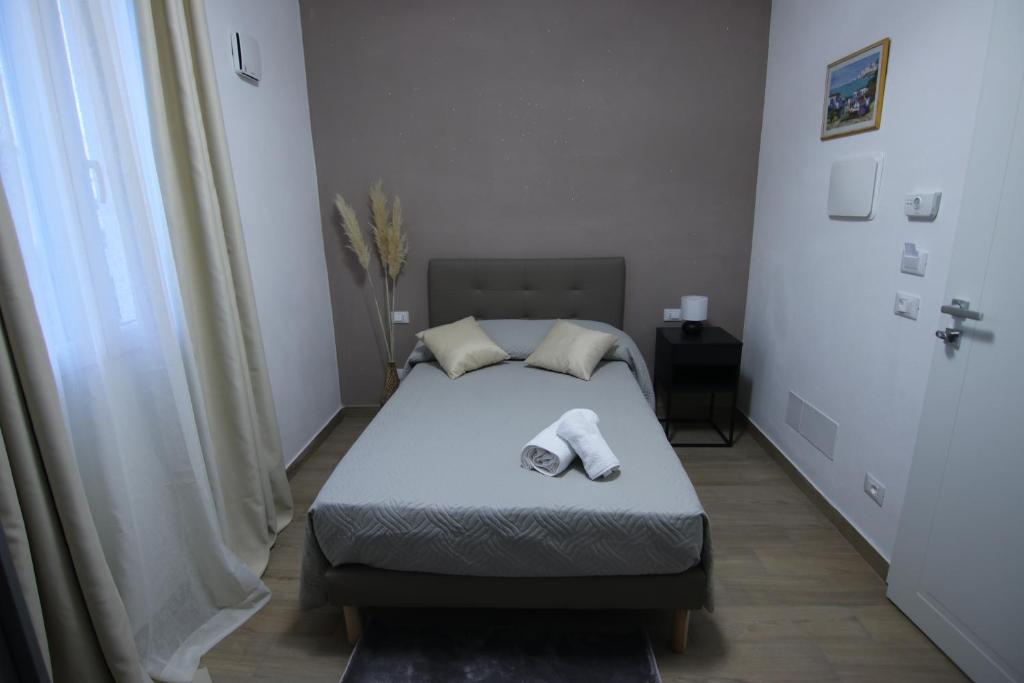 a bedroom with a bed with two towels on it at Franciacorta Rooms in Corte Franca