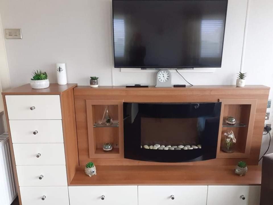 a entertainment center with a television on top of it at 19 orchid Meadows in Newbiggin-by-the-Sea