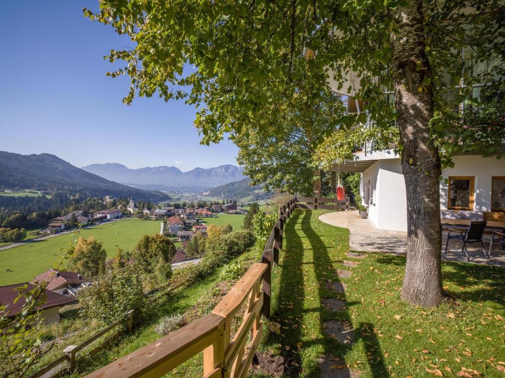 a view from a house with a fence and a tree at Blick auf's Schloss in Itter
