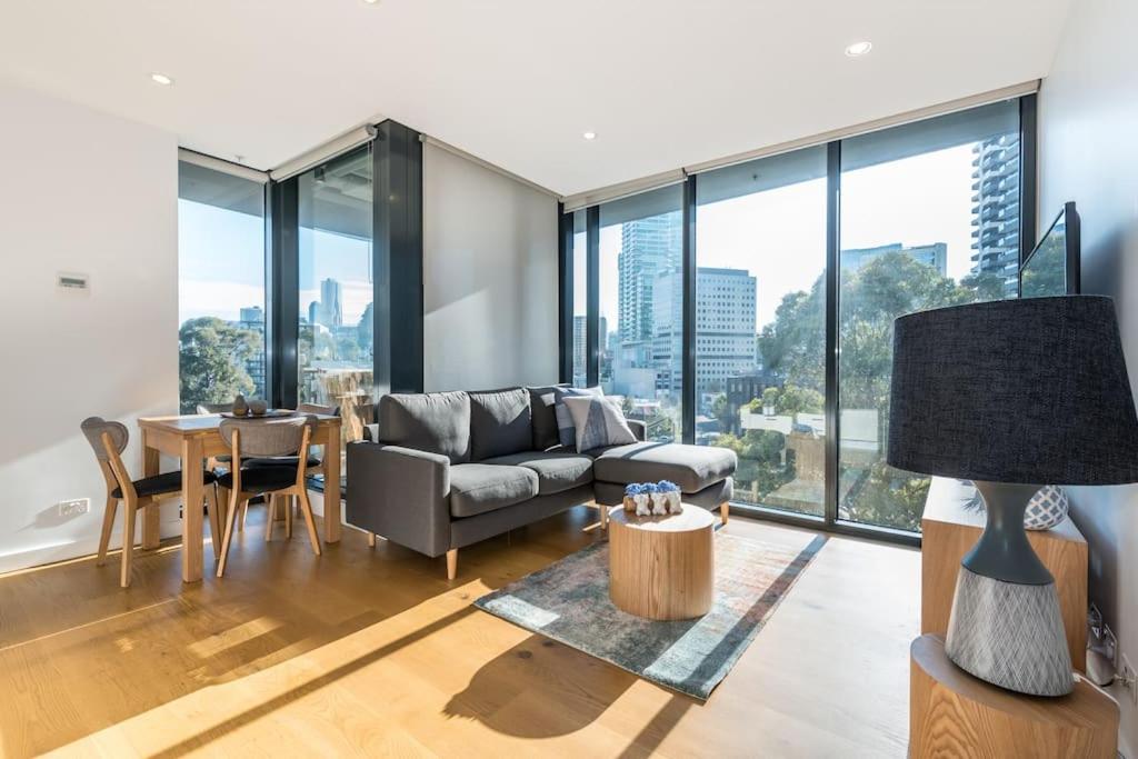 a living room with a couch and a table at South Melbourne Short Stay Luxury & Location 01728 in Melbourne