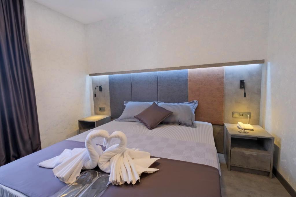 a bedroom with a large bed with swans on it at The Queen Hotel in Istanbul