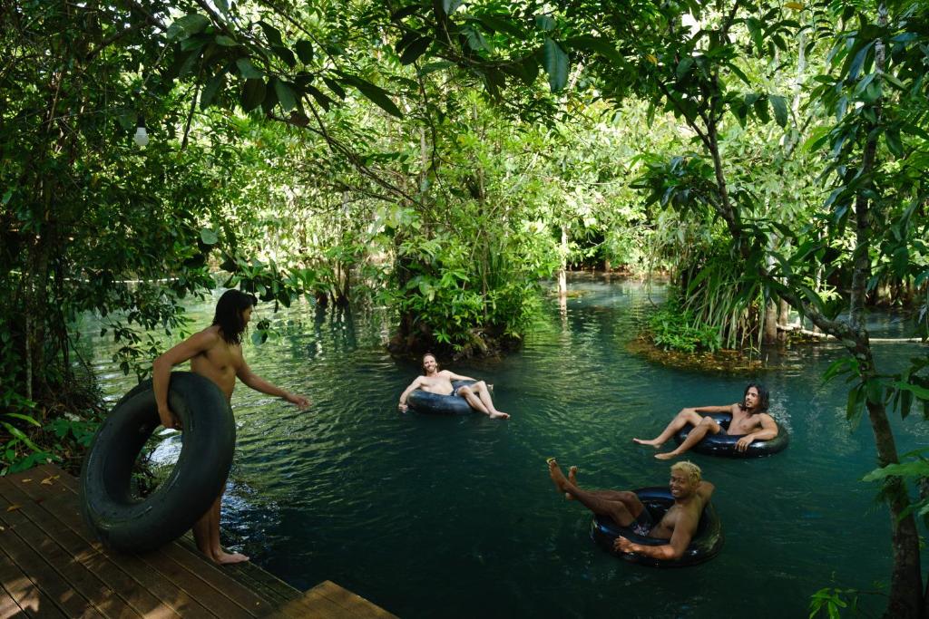 a group of people in the water in a river at Blu Monkey Pooltara Krabi Hotel & Villas Pet Friendly in Tha Lane Bay