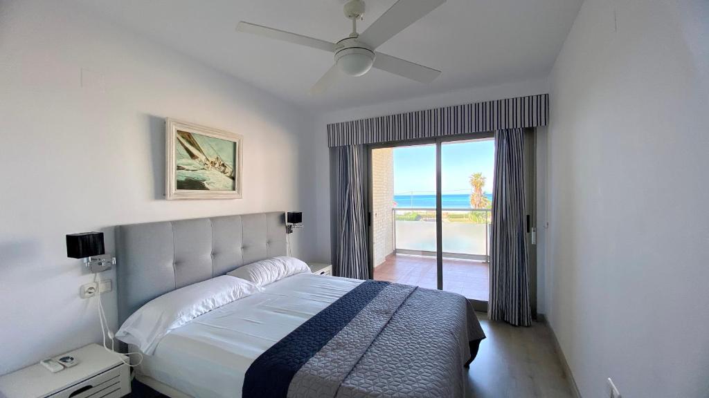 a bedroom with a bed and a view of the ocean at Tierra de Mar VYBdenia in Denia