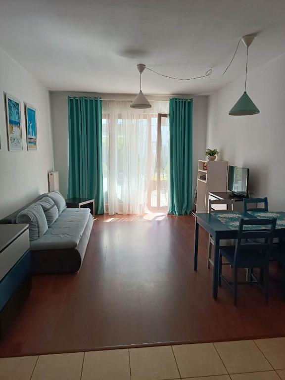 a living room with a couch and a table at Platan 3 in Świnoujście