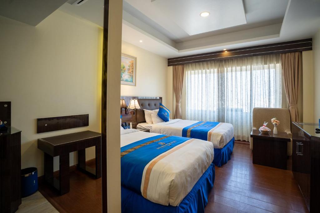 Postel nebo postele na pokoji v ubytování Shangrila Blu Hotel